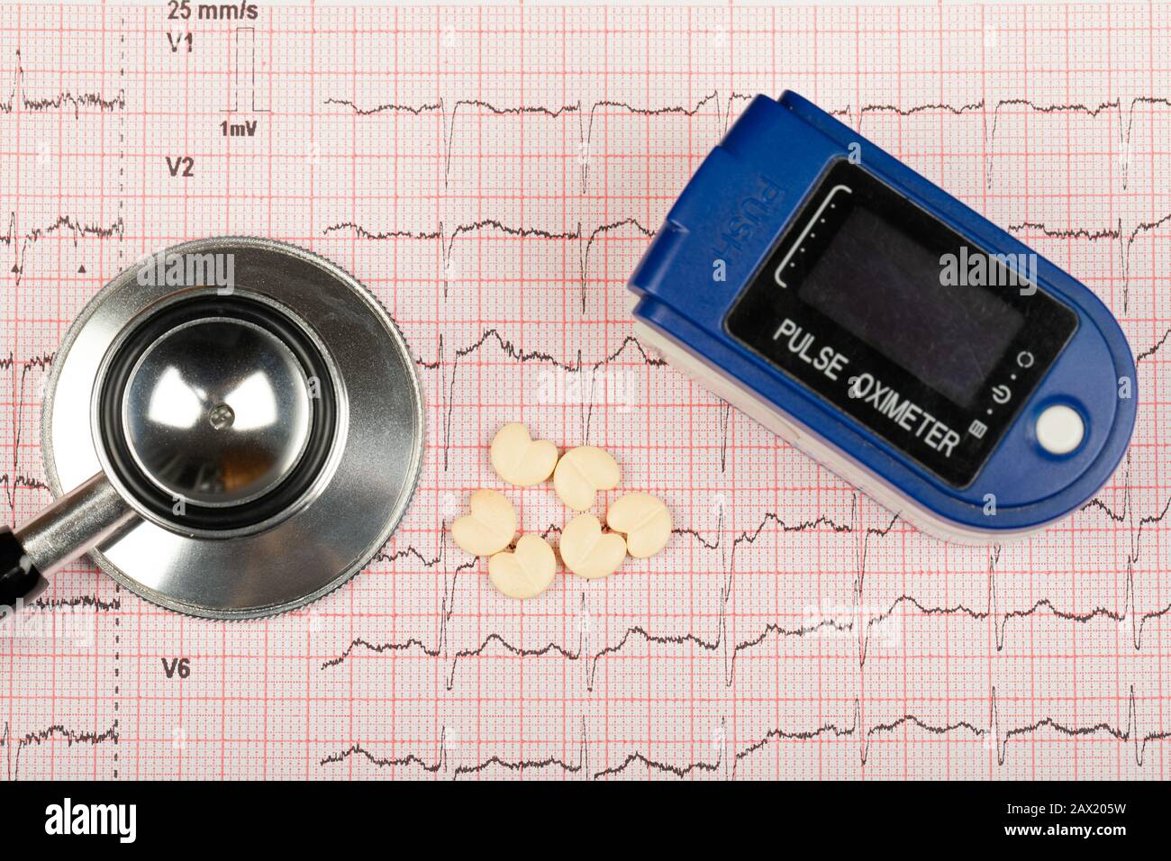 Electrocardiogram graph report with stethoscope and pulse oximeter on it Stock Photo