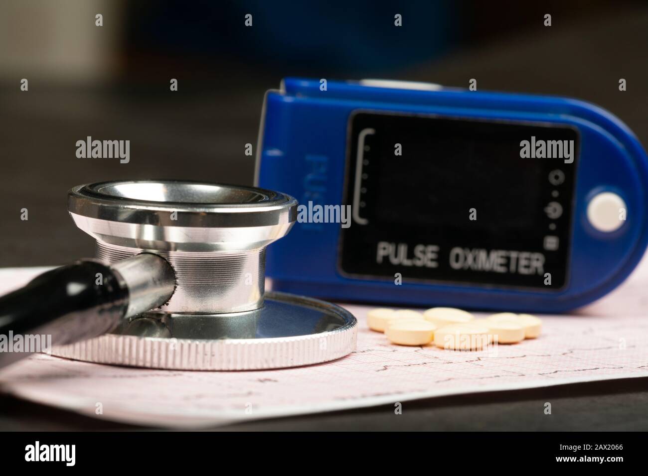Electrocardiogram graph report with stethoscope and pulse oximeter on it Stock Photo