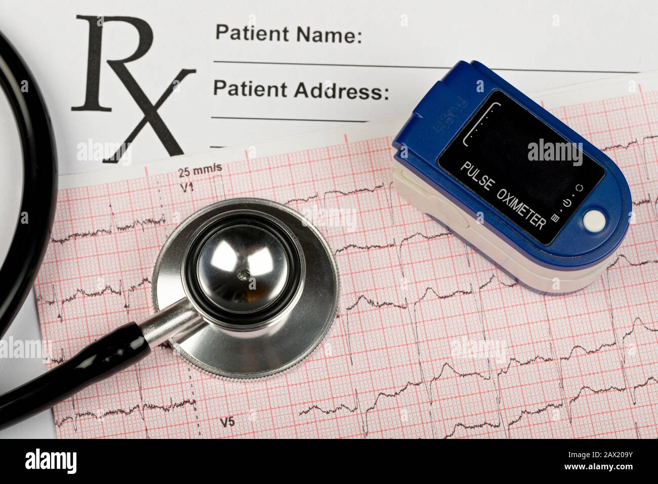 Electrocardiogram graph report with stethoscope and pulse oximeter on it Stock Photo