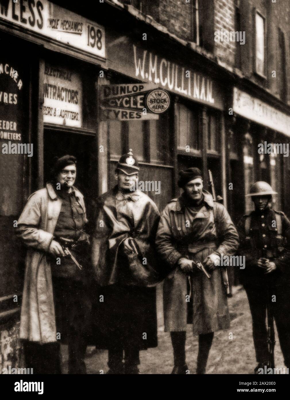 A Royal Irish Constabulary (RIC) policeman with a British soldier and two Auxiliaries. The Auxiliary Division of the Royal Irish Constabulary, was a paramilitary unit of the Royal Irish Constabulary (RIC) during the Irish War of Independence. It was set up in July 1920 and made up of former British Army officers, to conduct counter-insurgency operations against the Irish Republican Army (IRA). The Auxiliaries became infamous for their reprisals on civilians and civilian property in revenge for IRA actions. Stock Photo