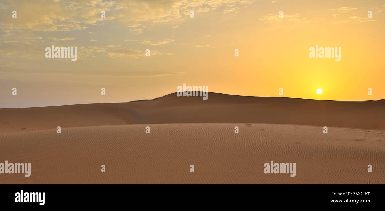 Sand desert at sunset, desert sunset, sand under the setting sun, wahiba Sands Oman Stock Photo