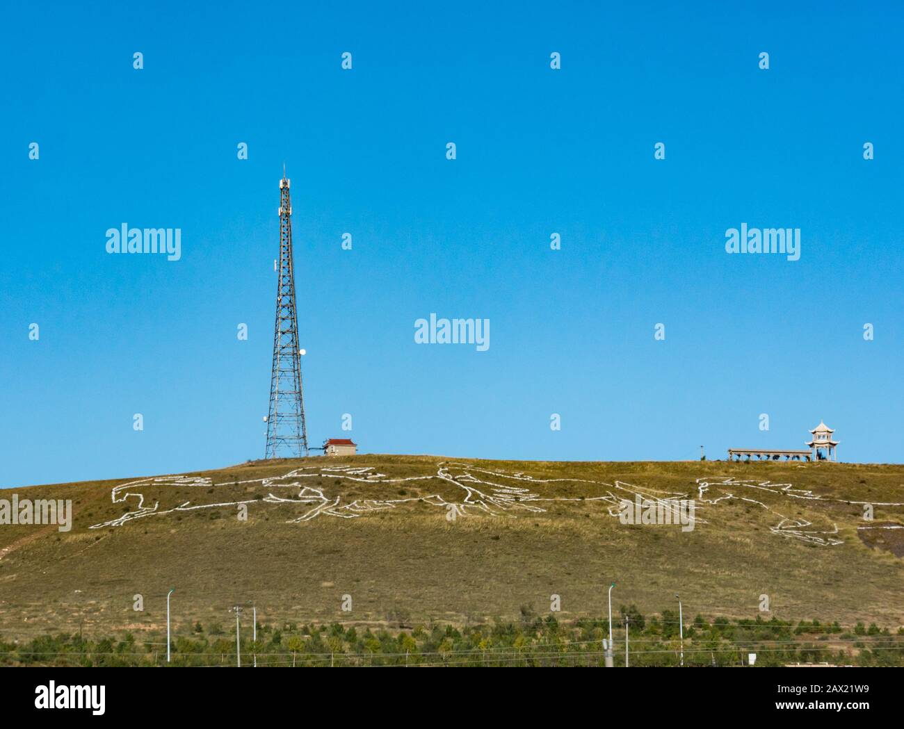 White wild horses drawn on hillside seen from Trans-Mongolian Express train window, China, Asia Stock Photo