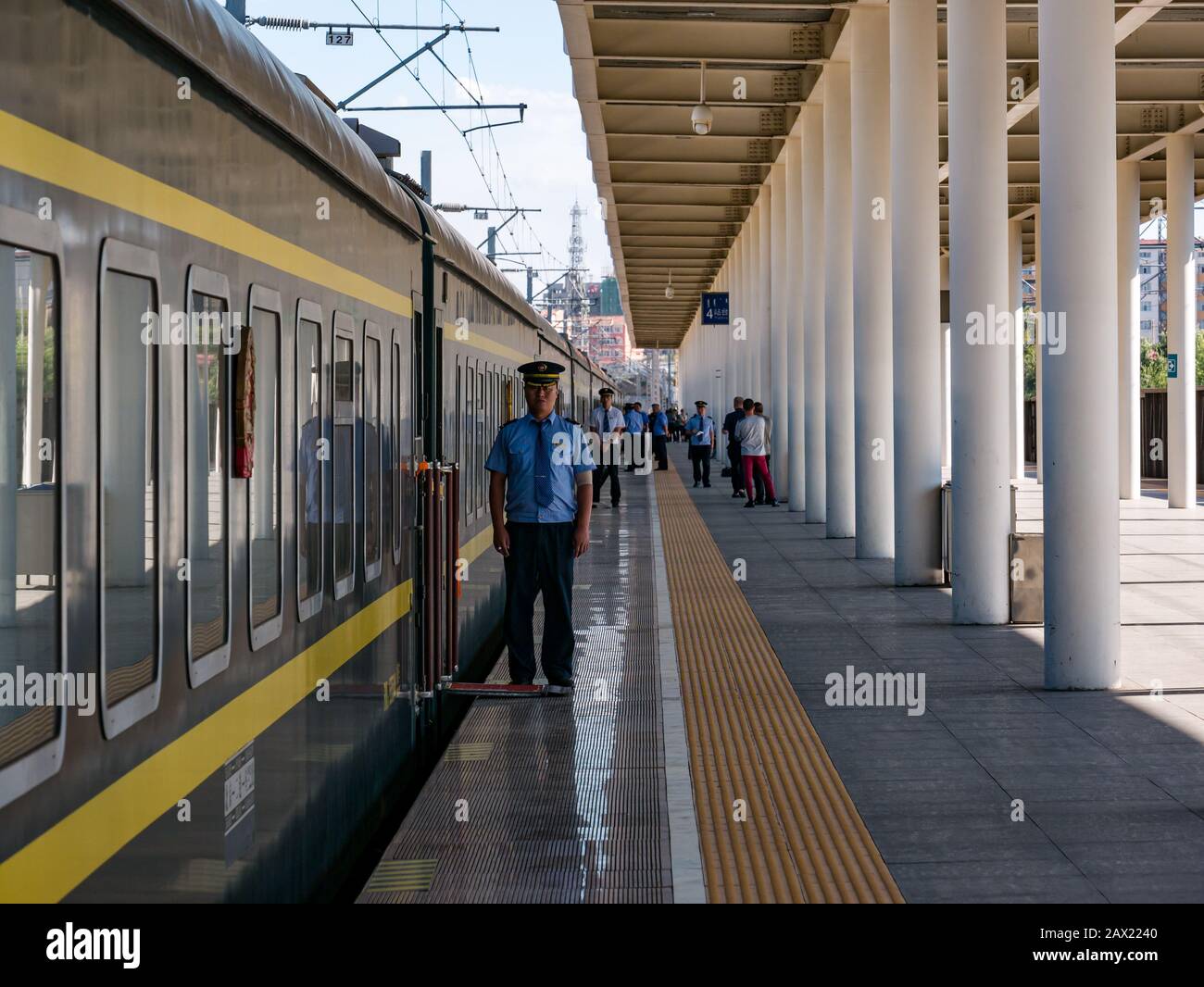 Jining railway station platform with uniformed guard at first class carriage of Trans-Mongolian Express train, China, Asia Stock Photo