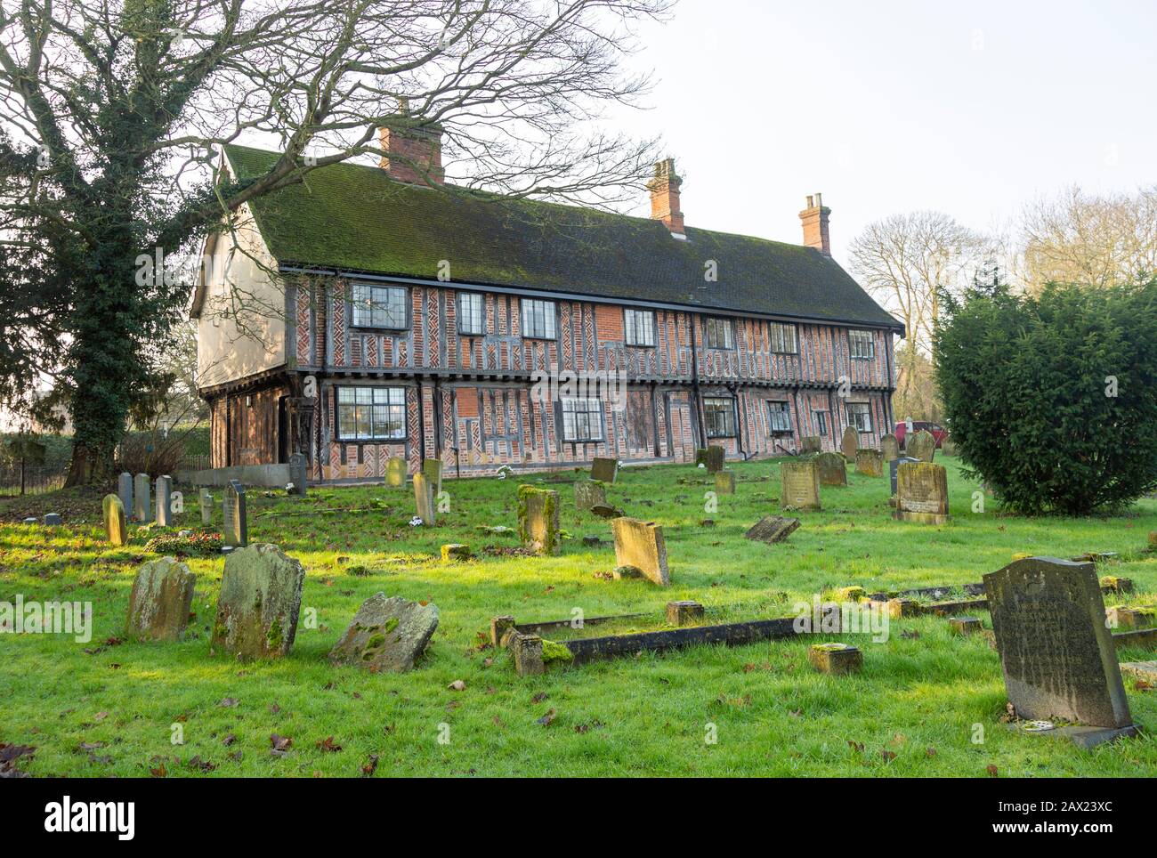 Historic medieval building Fox and Goose pub and church gravestones