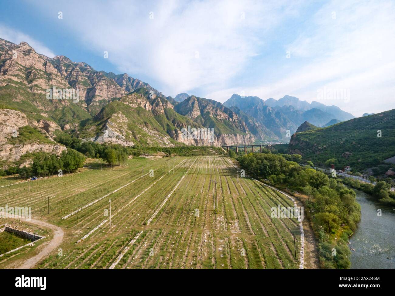 Mountains and agricultural scenery seen from Trans-Mongolian Express train window, China, Asia Stock Photo