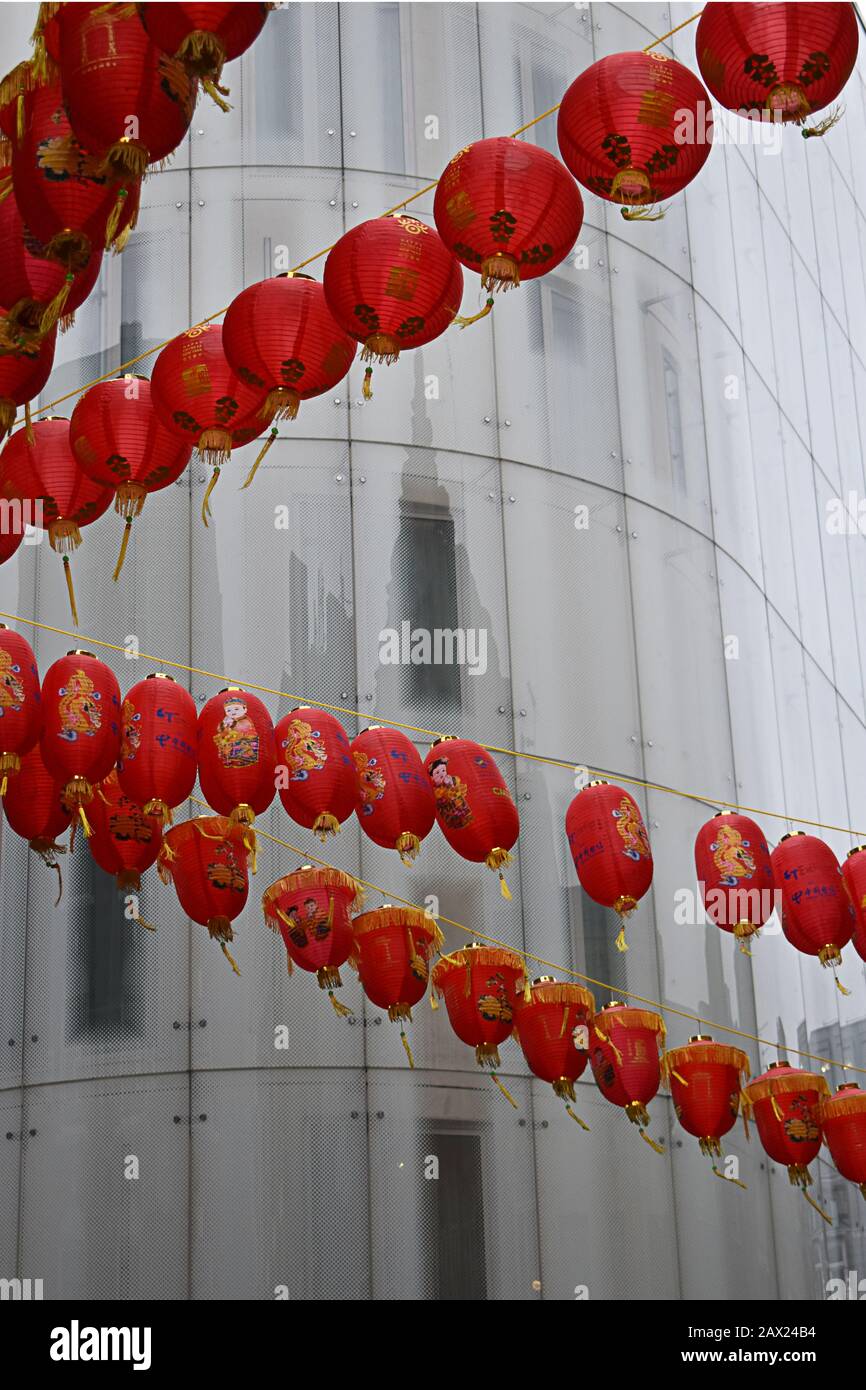 Red Chinese New Year lanterns set against white building in Chinatown, Soho, London Stock Photo
