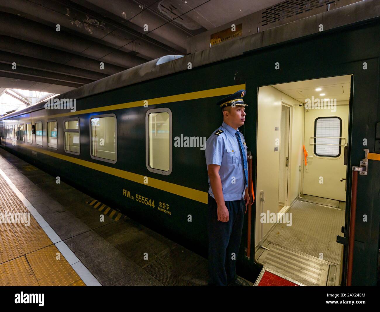Trans-Mongolian Express train at station platform with uniformed guard at first class carriage, Beijing railway station, Beijing, China, Asia Stock Photo