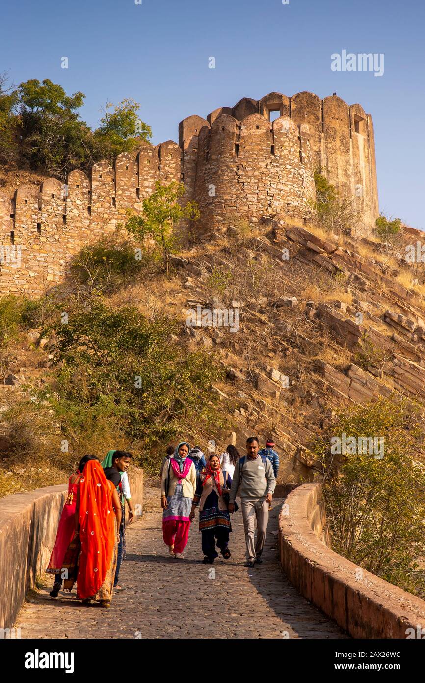 India, Rajasthan, Jaipur, Indian visitors walking up Nahargarh Road towards fort walls Stock Photo