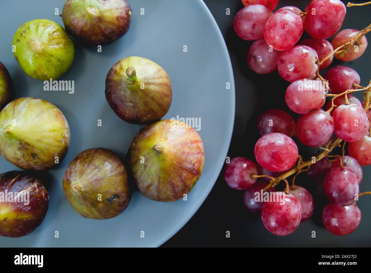 Fresh grapes and figs on the kitchen table Stock Photo