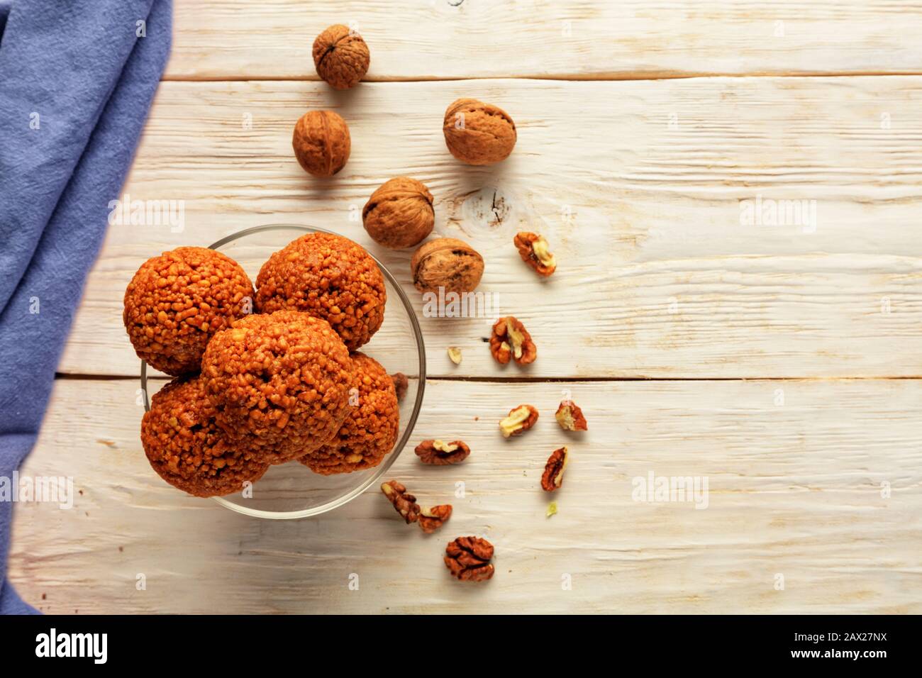 Homemade energy balls with walnuts, peanut, honey and banana. Vegan Vegetarian Raw Snacks. Healthy Sweet Food. Copy space. Flat lay, top view. Stock Photo