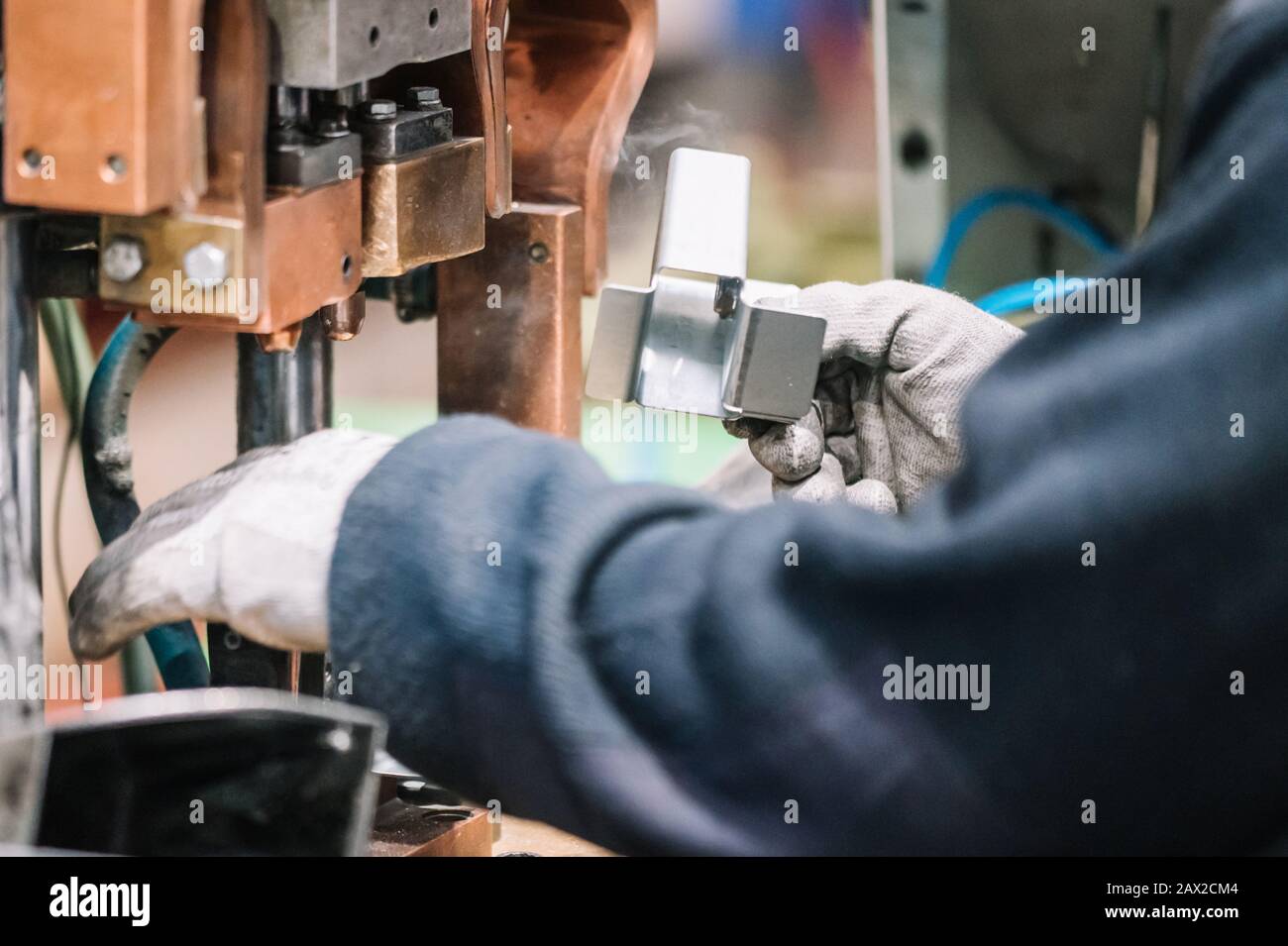 Spot welding machine Industrial automotive part in factory. Operator working in industry . Stock Photo