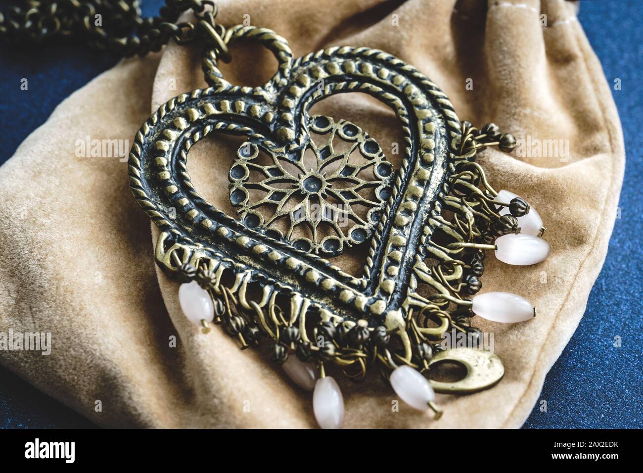 Ethnic boho style heart pendant with white beads Stock Photo