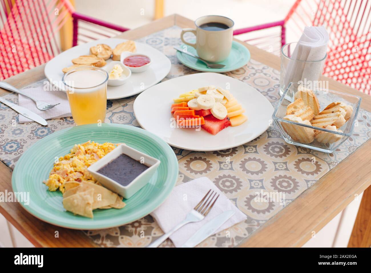 breakfast for two in the hotel with eggs, toast and fruit Stock Photo