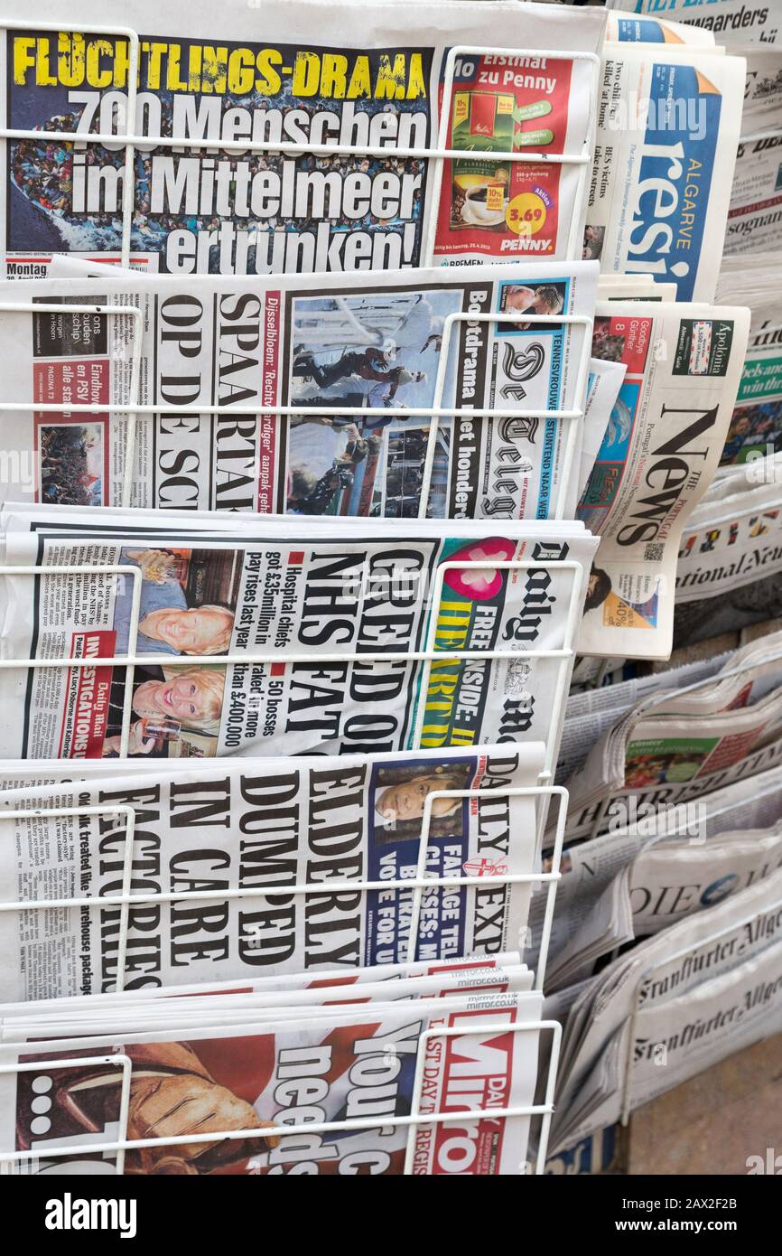 Rack of foreign newspapers on sale, Albufeira, Algarve, Portugal Stock Photo