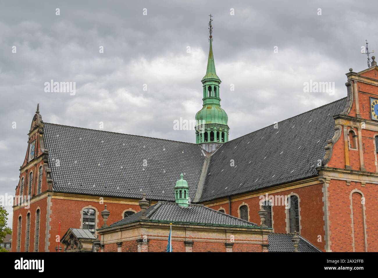 The spire of the 16th century Holmen Church in the historic center of Copenhagen, Denmark, under a cloudy sky. Stock Photo