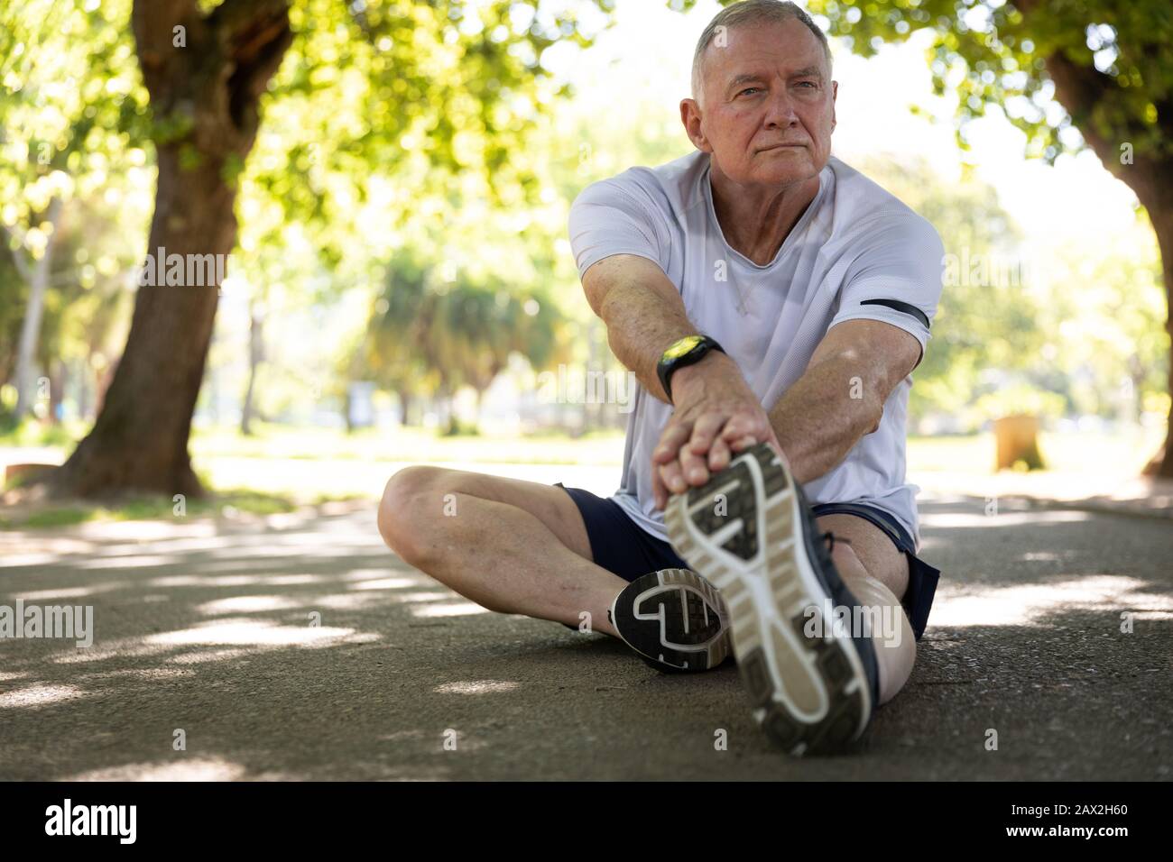 Jogger stretching in the park Stock Photo