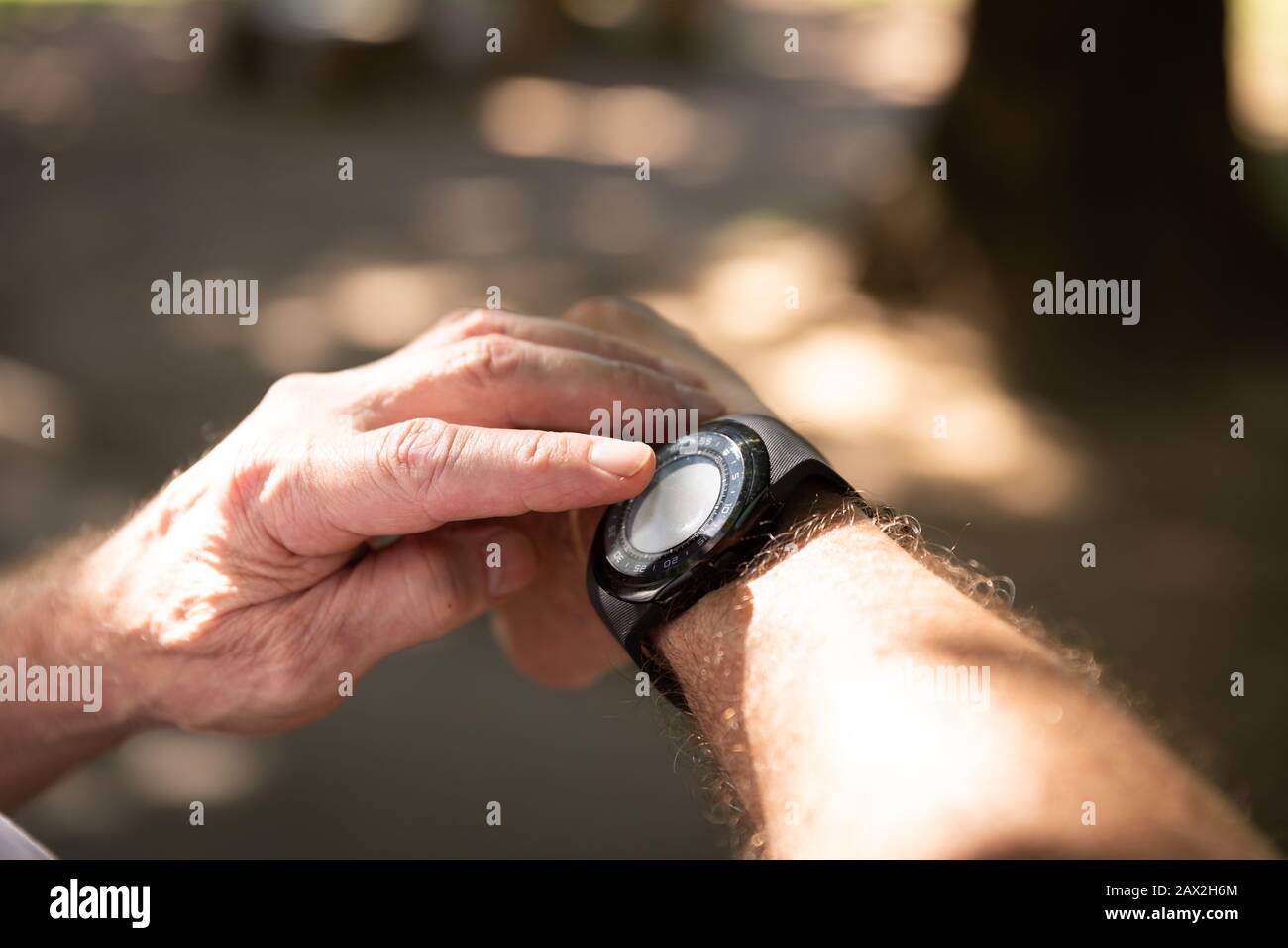 Jogger using a smart watch in the park Stock Photo