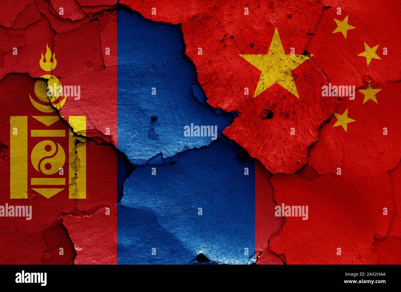 flags of Mongolia and China painted on cracked wall Stock Photo