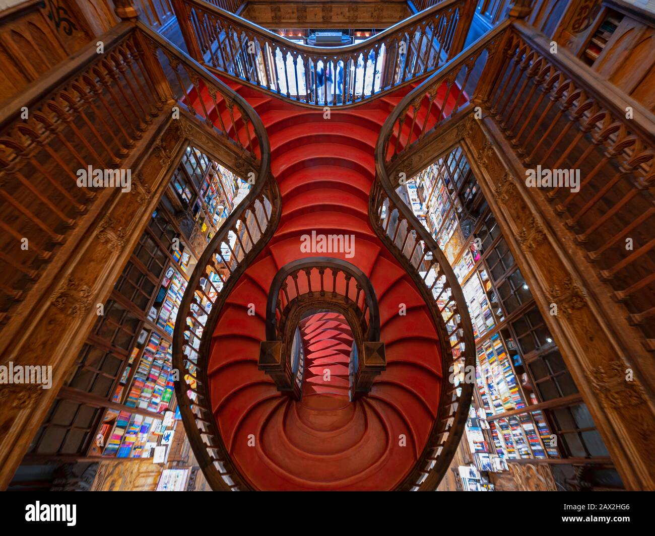 Interiors of Lello Bookstore (Portuguese: Livraria Lello) showing its famous wooden staircase in the Historic Center of Porto, Portugal. Stock Photo