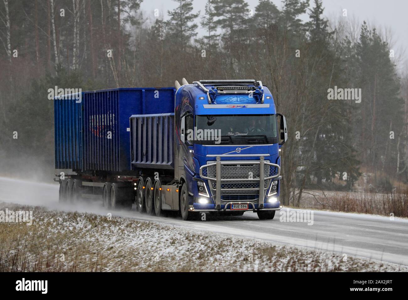 Blue Volvo FH16 for construction haul of E Gustafsson Oy on the road in winter snowfall. Salo, Finland. February 7, 2020. Stock Photo