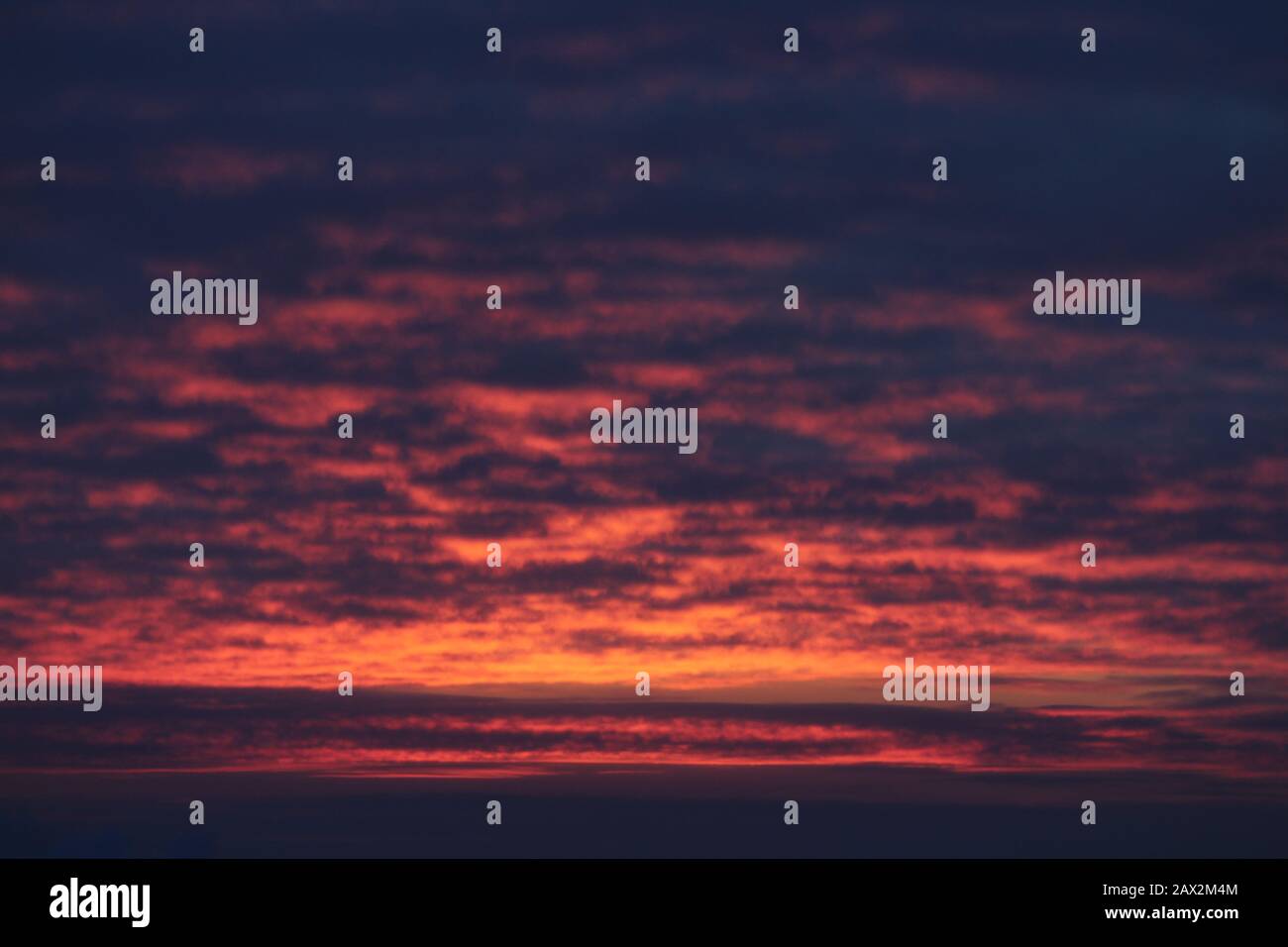 Crimson Sky With Clouds Illuminated By The Sun At Sunset Or Sunrise At Dusk Stock Photo Alamy