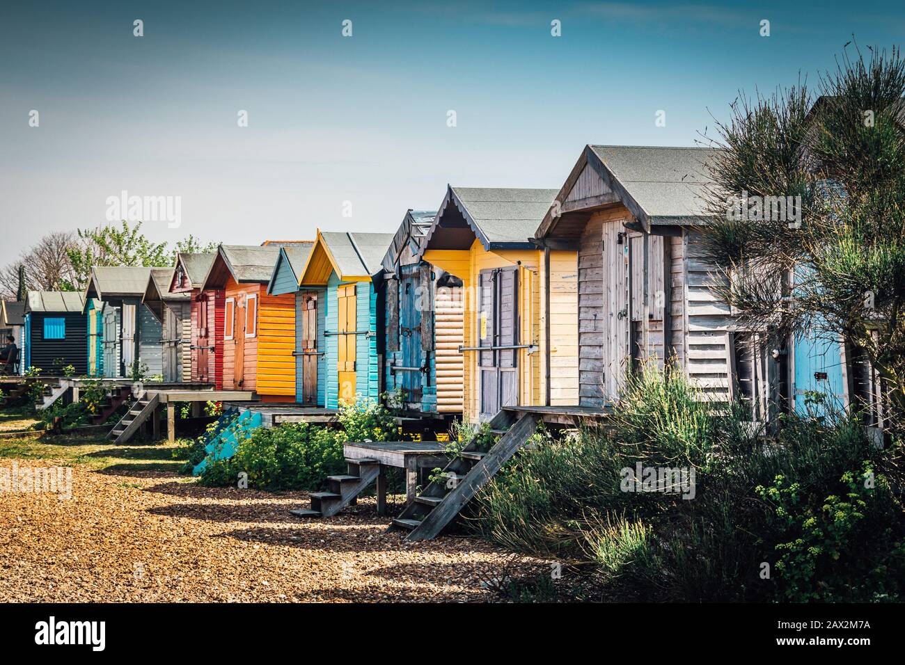 Colorful cabanas lining the beach in the Southeast English town of Whitstable. Whitstable Bay Stock Photo
