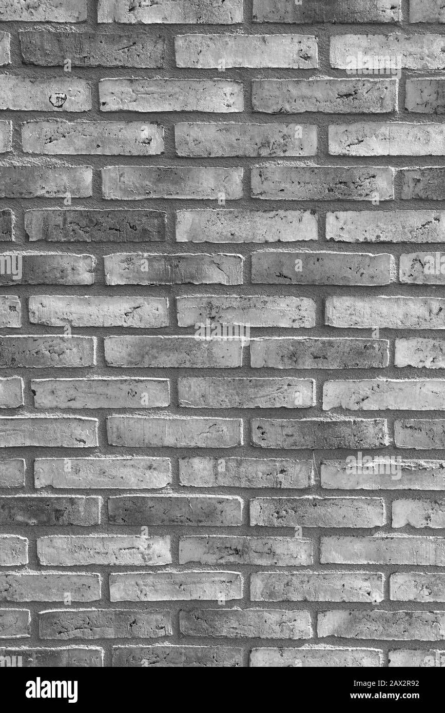 New monochrome-patterned brick facade. Monochrome background Stock Photo