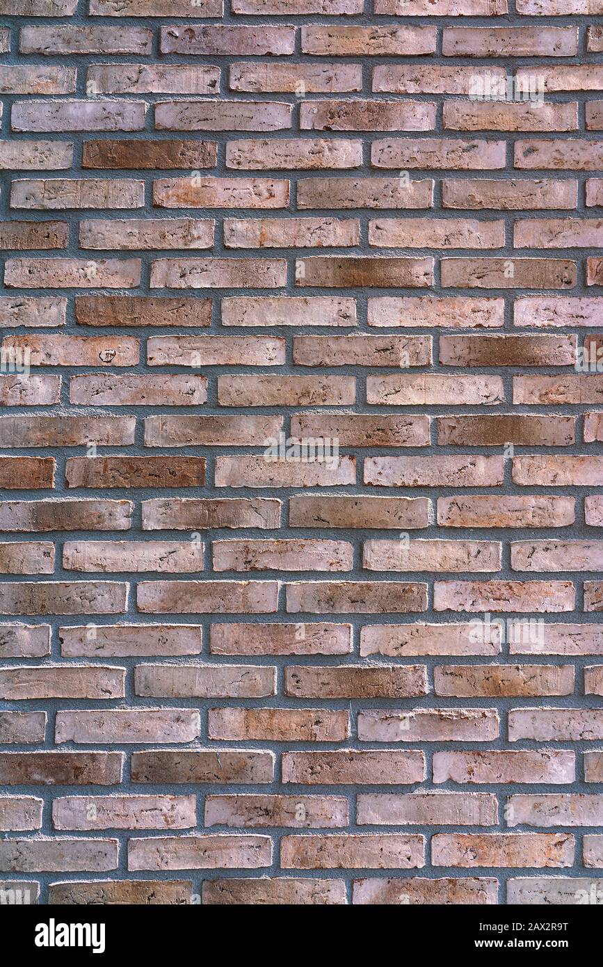 New brown-patterned brick facade. Background Stock Photo