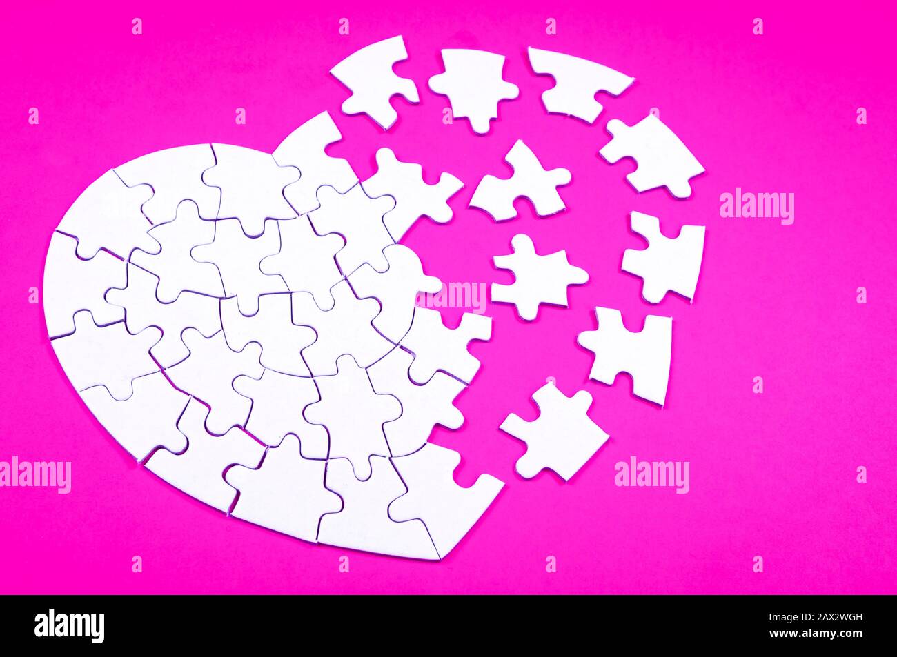 Heart rendered into white puzzle pieces on pink background Stock Photo ...