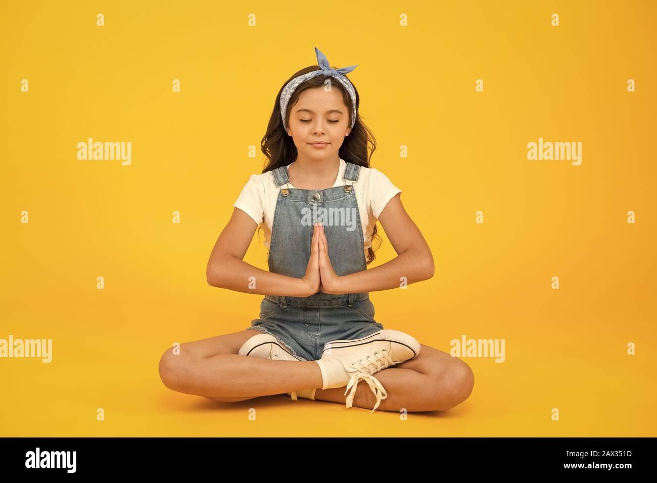 Inner calmness. Yoga meditation. Little child do meditation in healthy pose. Small girl enjoy meditation practice. Mindfulness meditation and concentration. Stock Photo