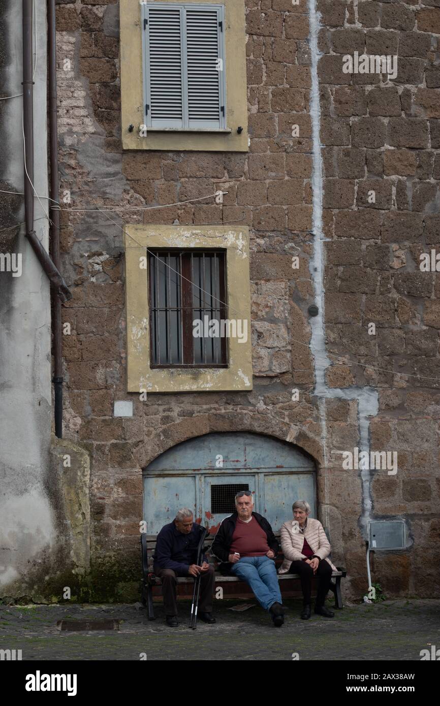 Three seniors sitting on a bench in Vetralla Italy Stock Photo