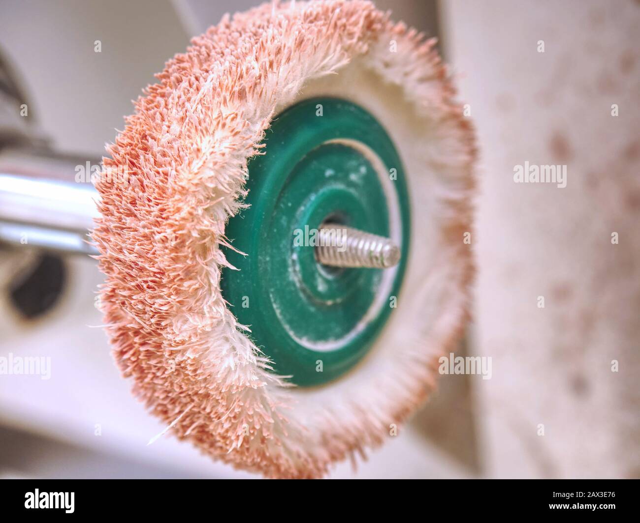 Dusty rotating metal brush. Power drill head with rotating brass