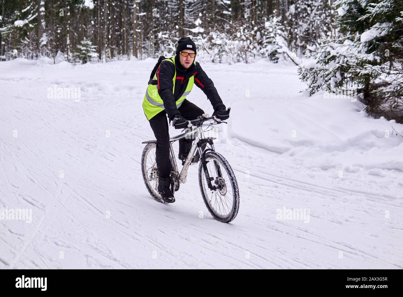 Perm, Russia - February 02, 2020: cyclist in winter in a snowy forest Stock Photo
