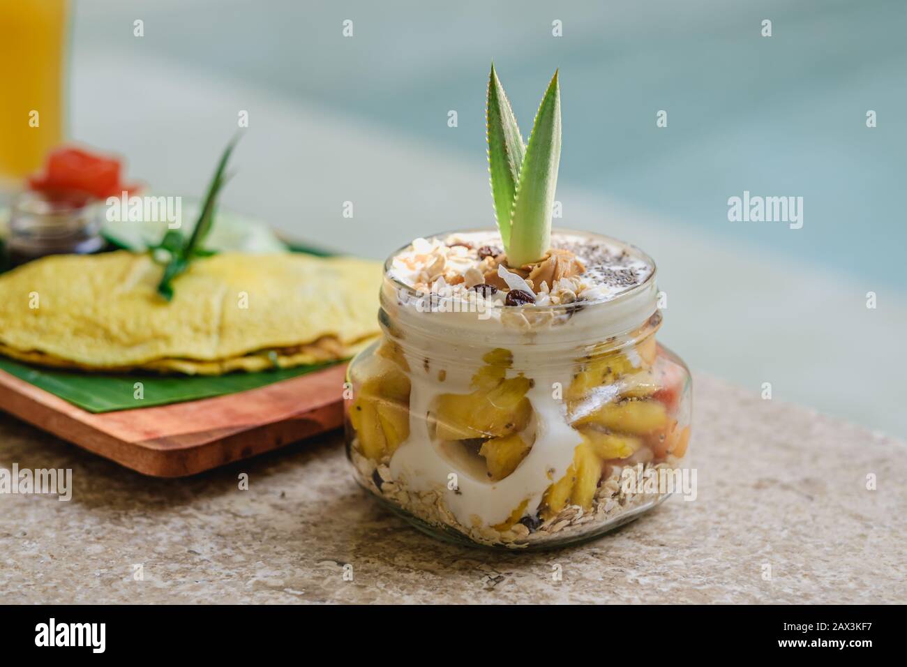 Tray of food between ice cream and juice in front of the pool Stock