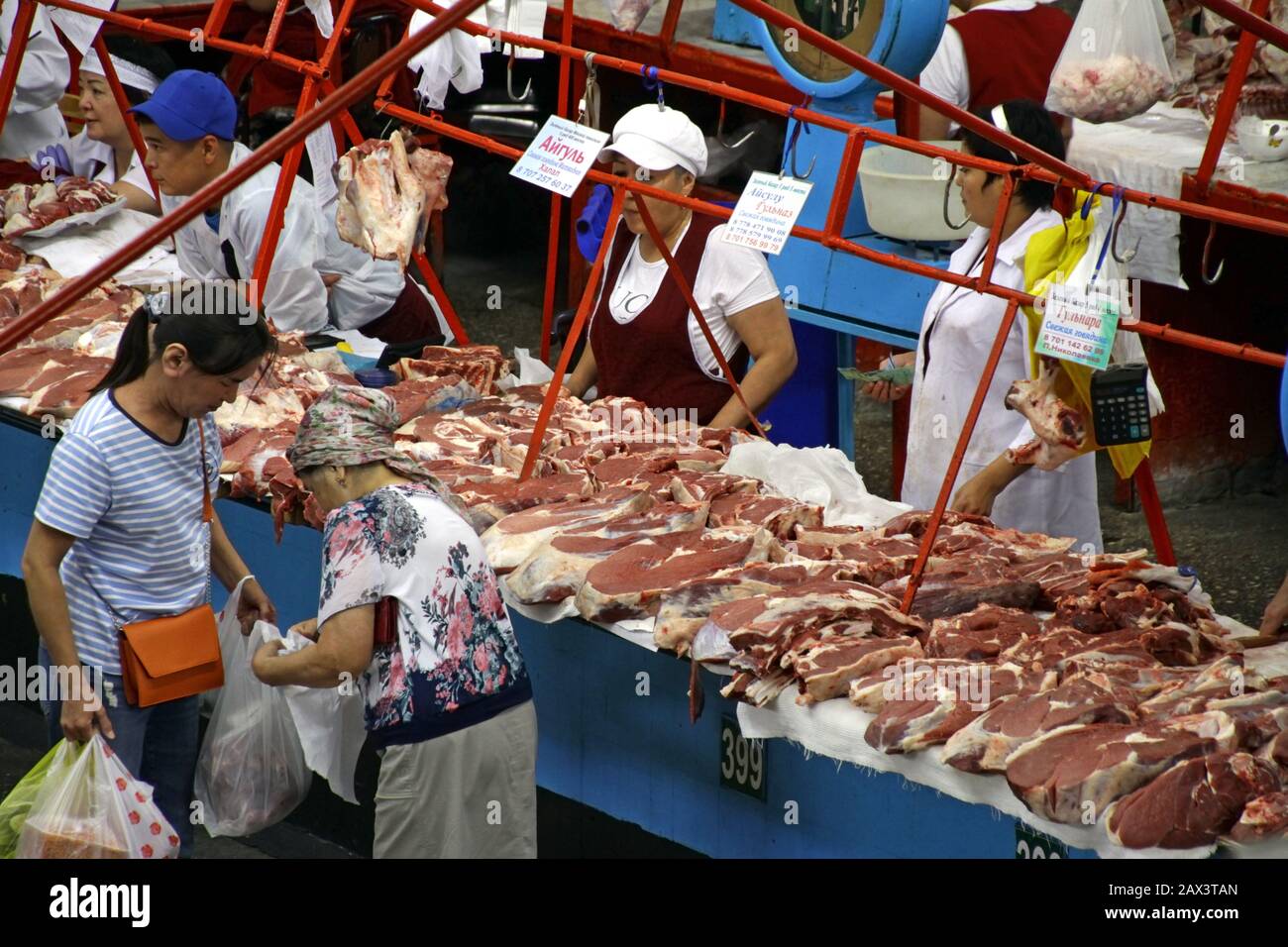 ALMATY, KAZAKHSTAN - Sep 09, 2019: 09 September 2019 - Almaty, Kazakhstan: People in the meat section of the Green Bazaar in Almaty, Kazakhstan, buyin Stock Photo