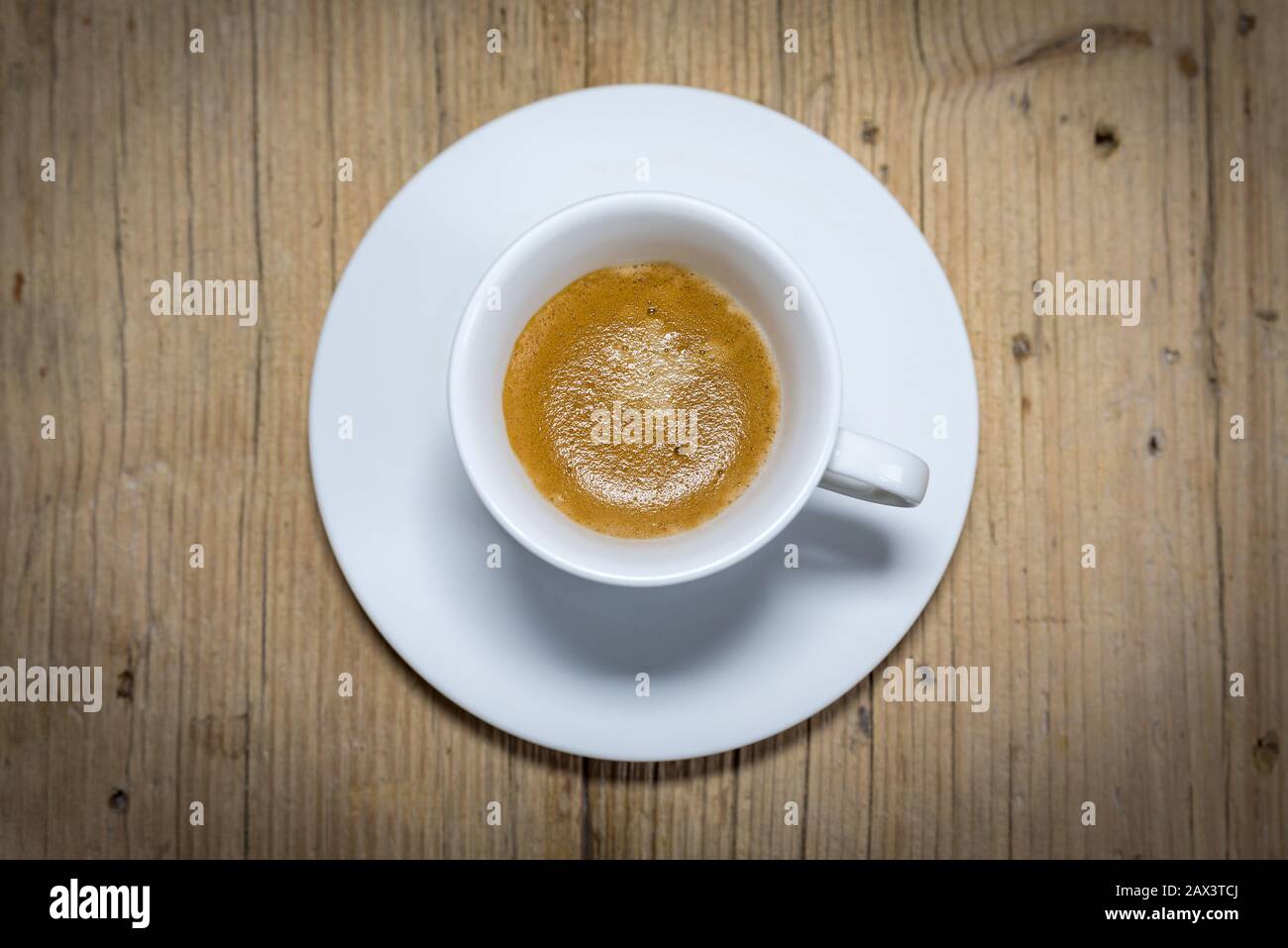 top view a cup of espresso coffee on wooden table background Stock Photo