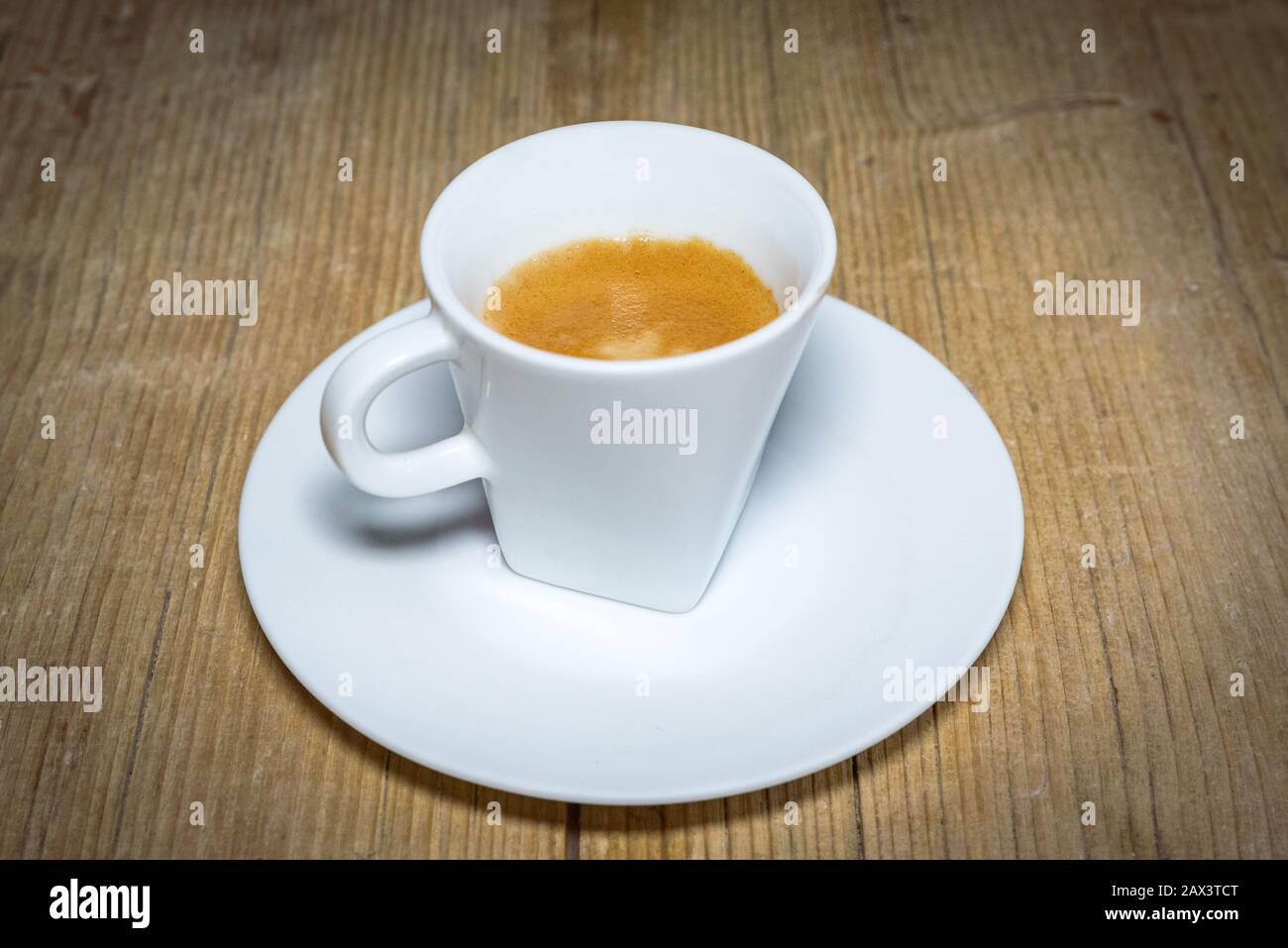 close up white cup of espresso on vintage wooden table Stock Photo