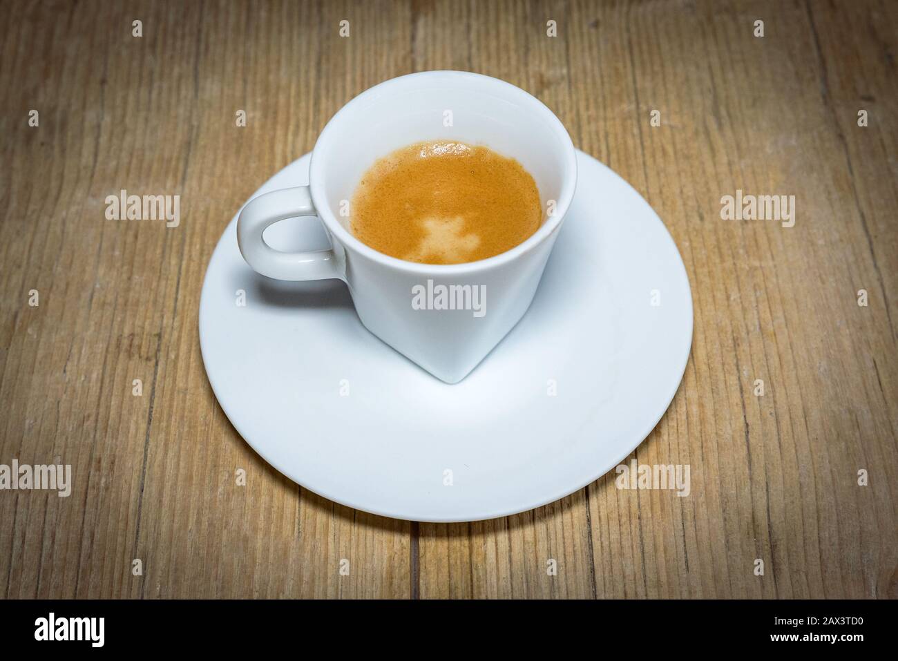 close up white cup of espresso on vintage wooden table Stock Photo