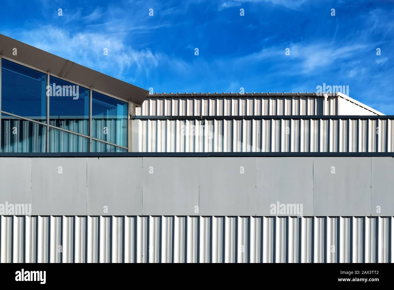 Modern industrial building with white corrugated steel wall panel Stock Photo