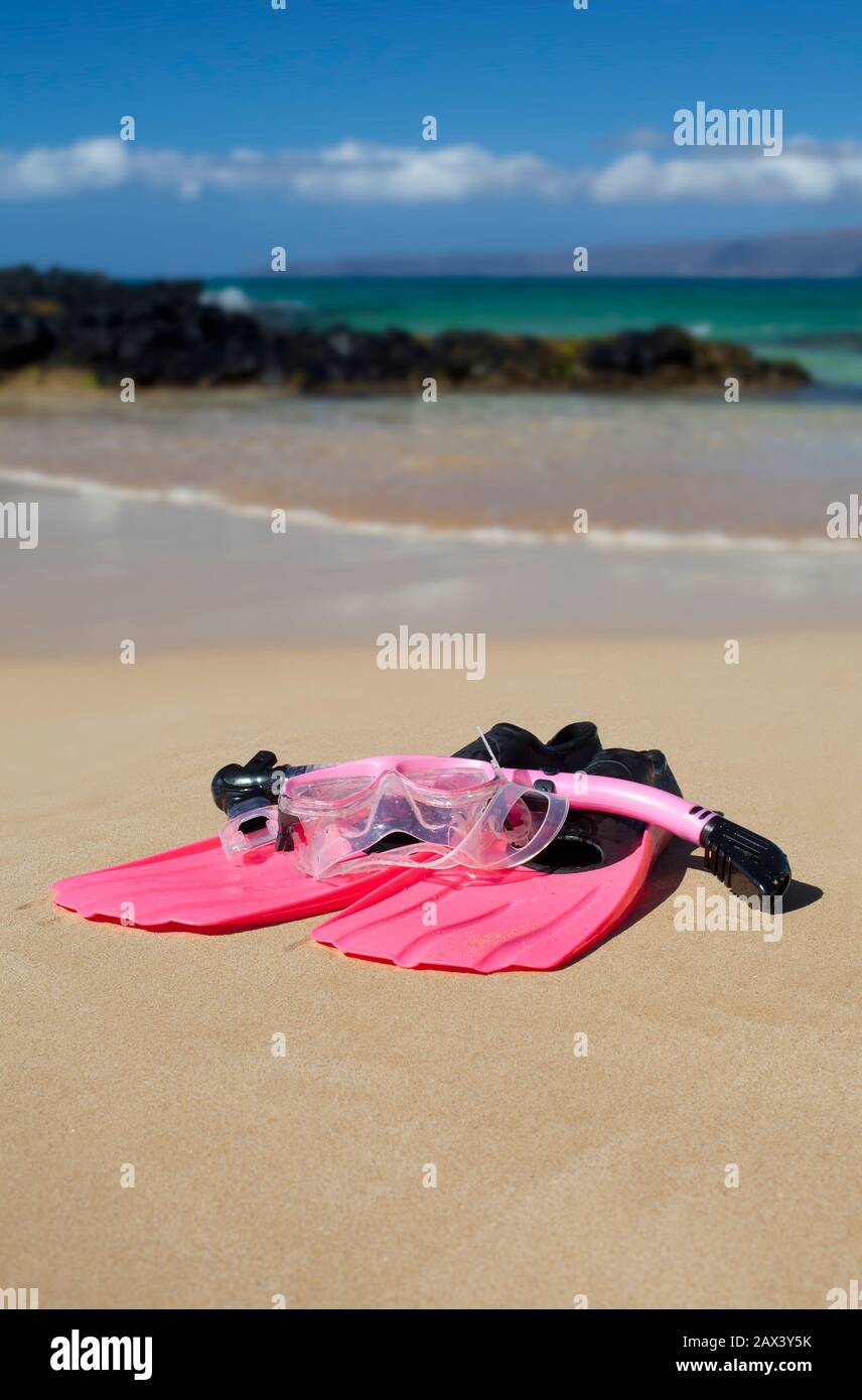 Fins, snorkel, and mask on the beach in the tropics, at Makena, Maui,, Hawaii. Stock Photo
