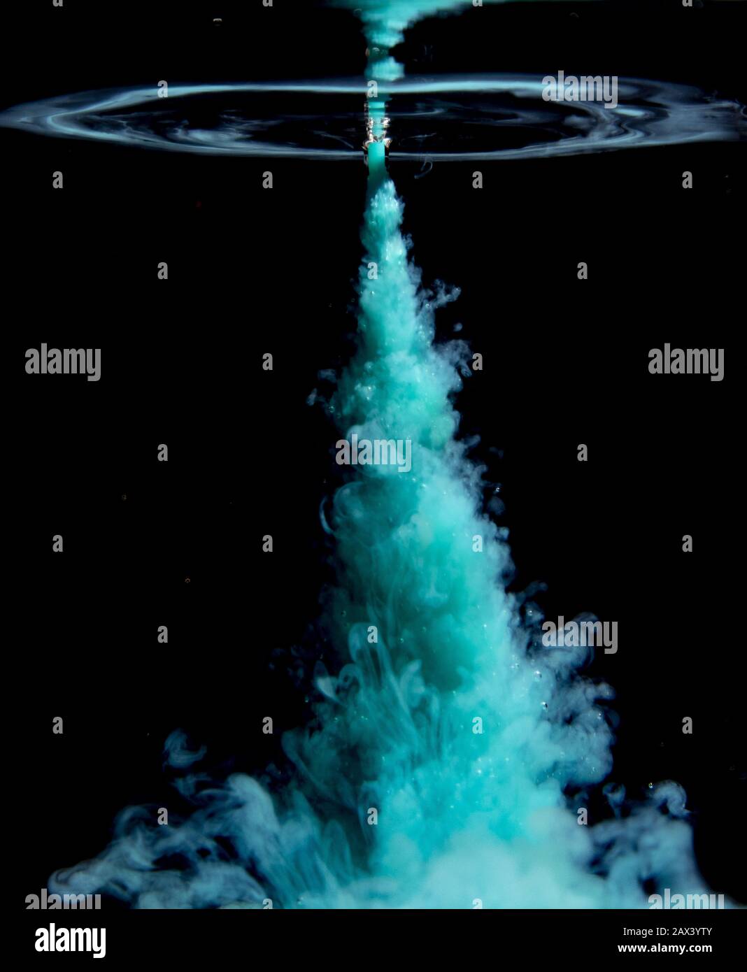 Abstract concept of teal color ink drop plume in water on an isolated ...