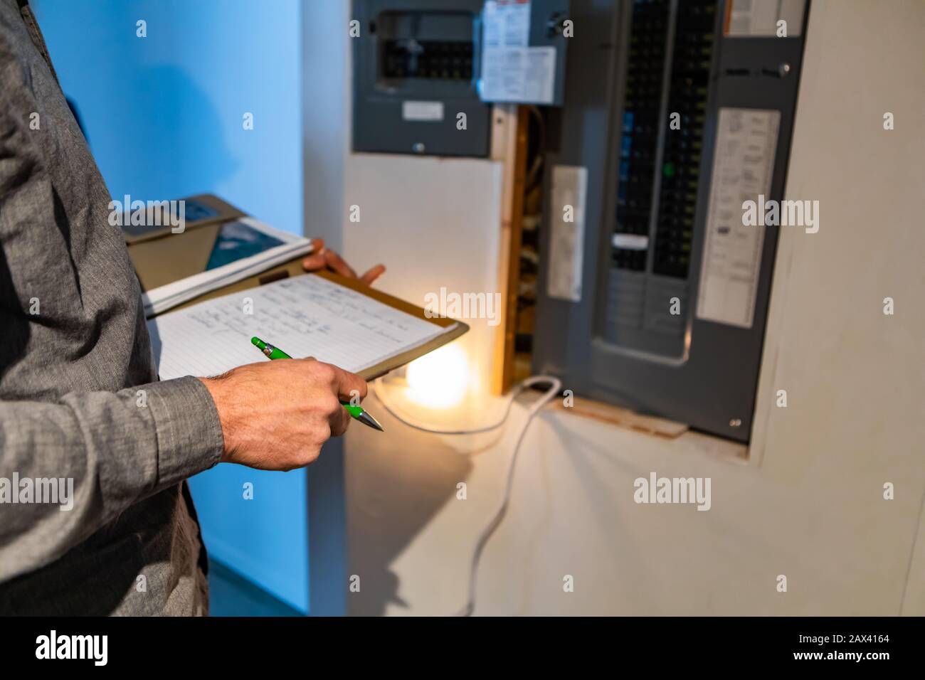 home Inspector in front of electric distribution board during