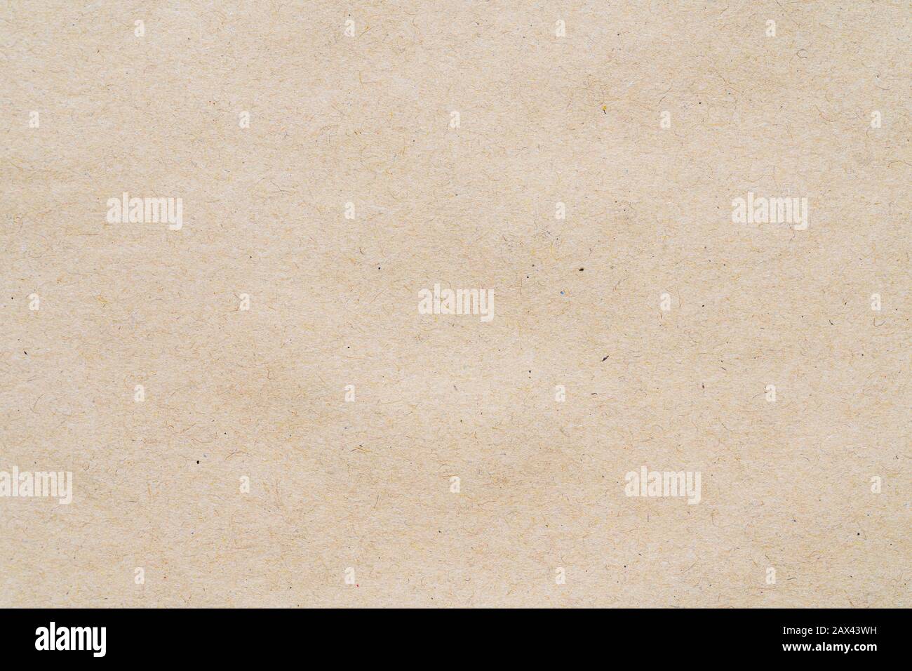 Light yellow pattern from sheet of recycled carton. Close-up detail photomicrography view of abstract texture recycled eco-friendly cardboard material Stock Photo