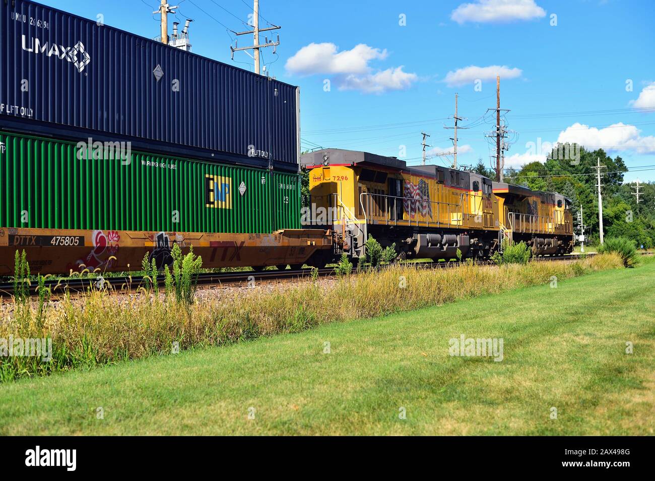 Geneva, Illinois, USA. A Union Pacific intermodal freight train, lead by two locomotive units, passing through Geneva, Illinois. Stock Photo