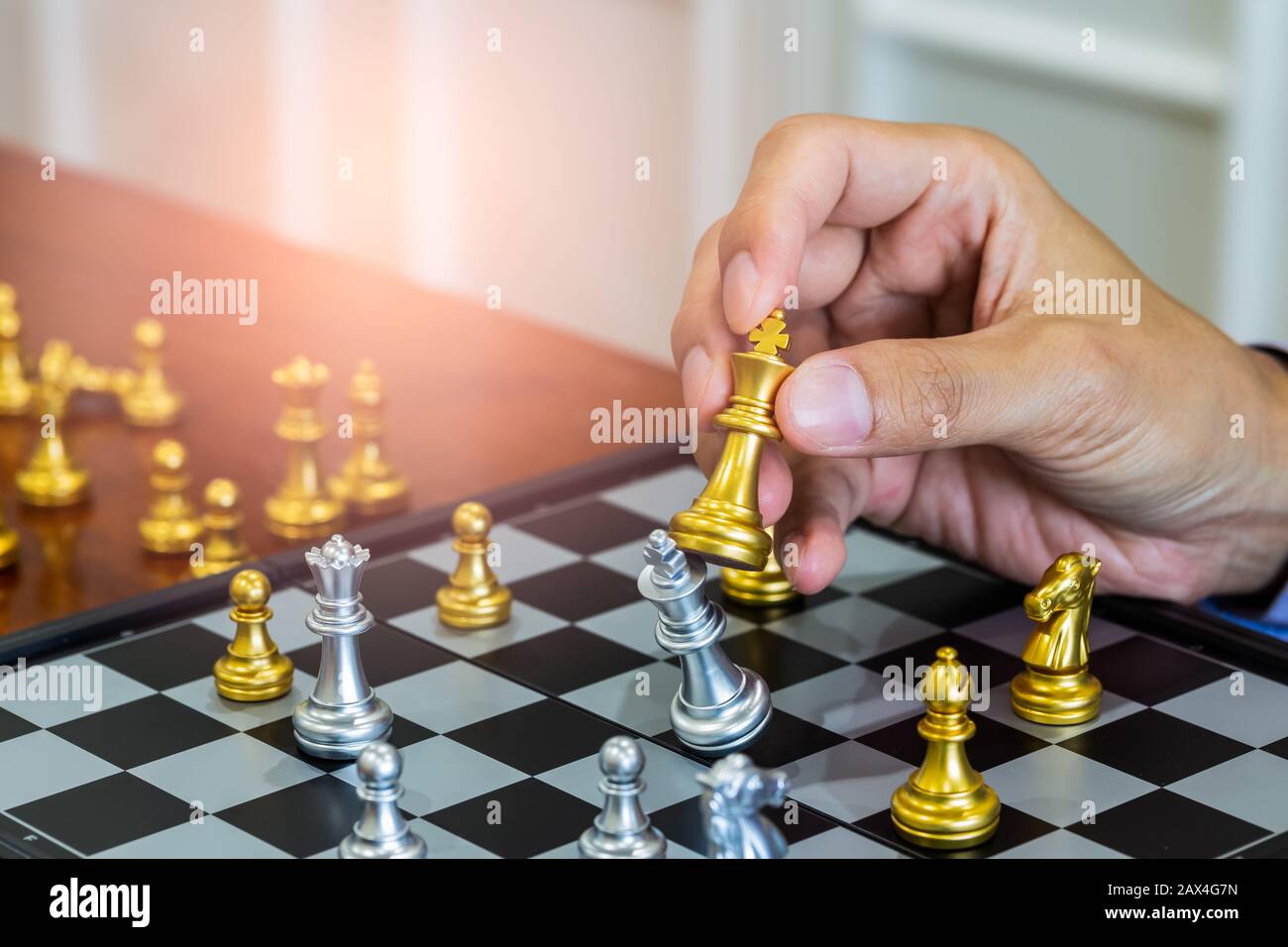 Chess game on chess board behind business man background. Business concept  to present financial information and marketing strategy analysis. Investmen  Stock Photo - Alamy