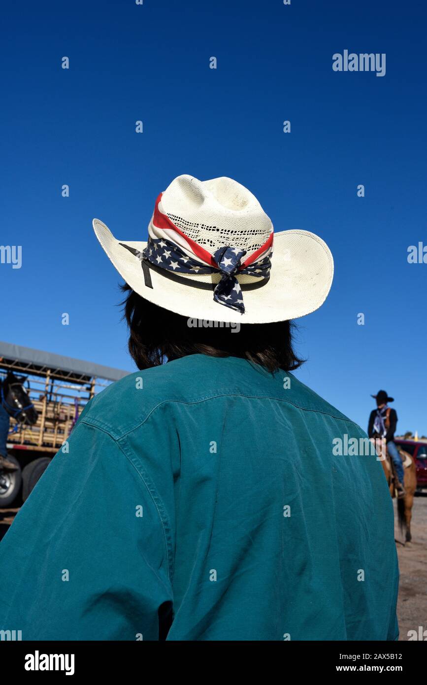 A member of a group called Cowboys for Trump wearing a hat decorated with an American flag participates in a pro-Trump rally in New Mexico USA Stock Photo