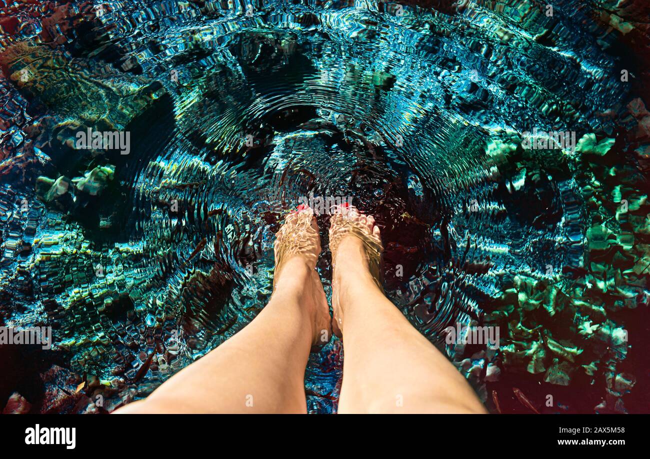 woman's feet in the water at the Cenote in Dzibilchaltun,  Yucatan, Mexico. Stock Photo