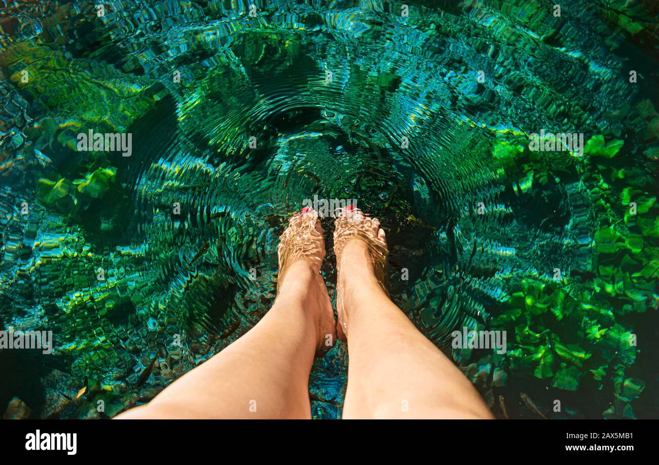 woman's feet in the water at the Cenote in Dzibilchaltun,  Yucatan, Mexico. Stock Photo