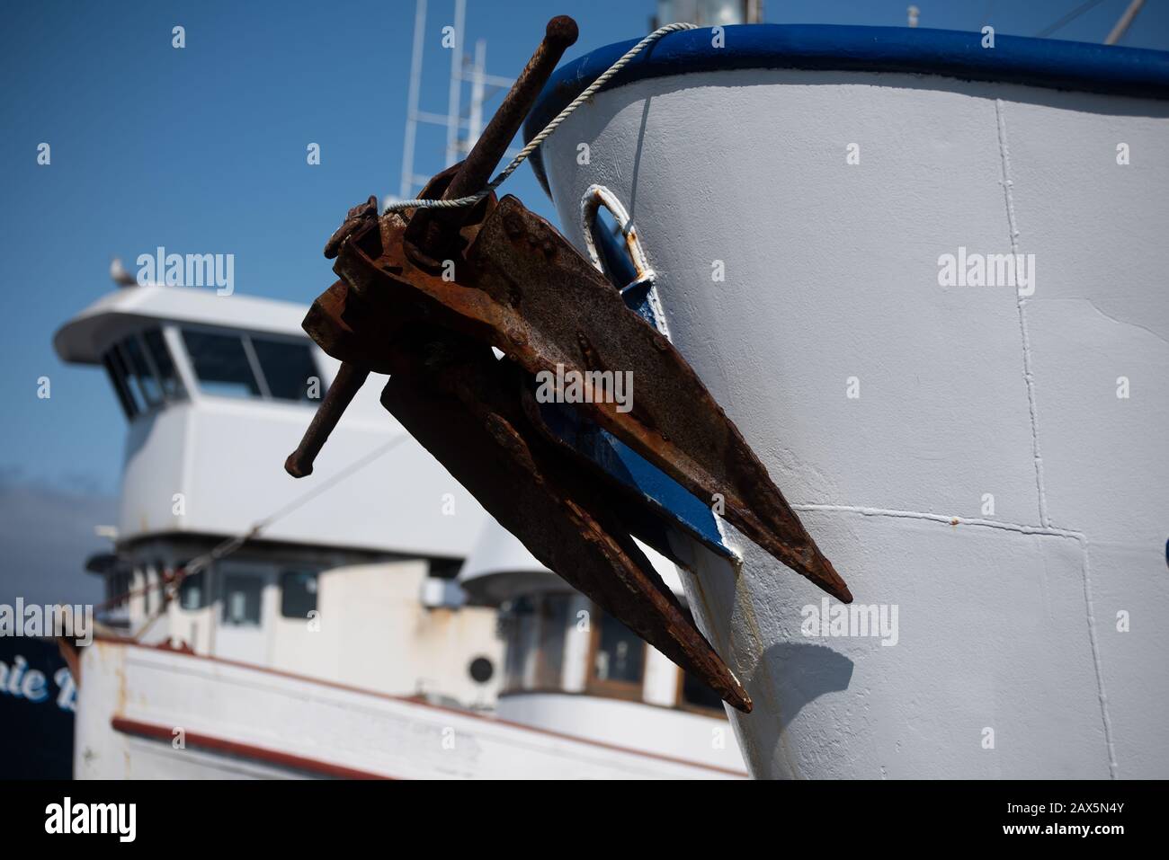 Rusty old anchor on a fishing boat Stock Photo