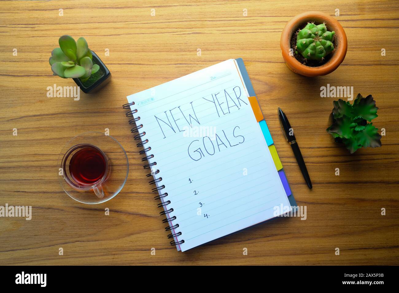 new year goals written on notepad on table  Stock Photo